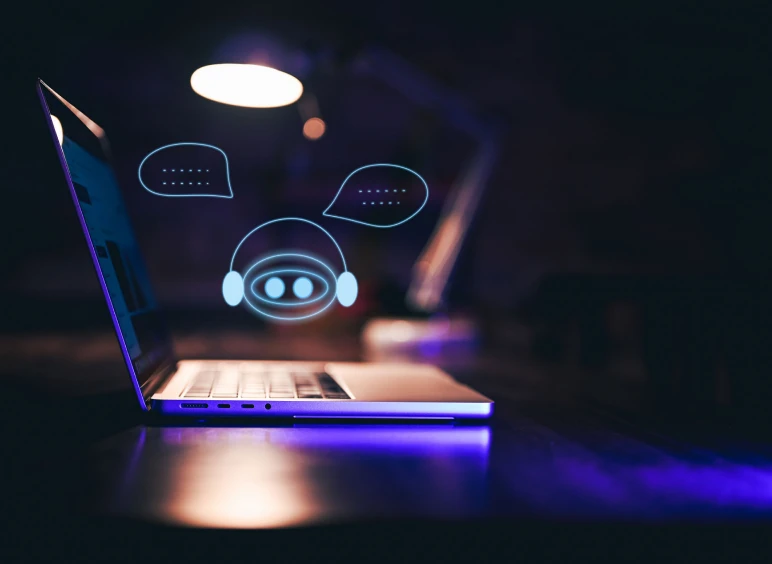 Laptop displaying chatbot hologram
